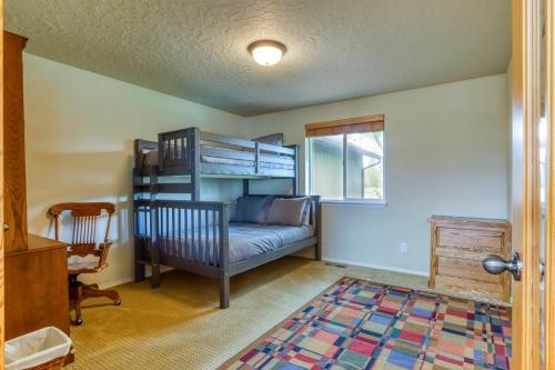 a bedroom with a bunk bed and a couch at Meadow Walk Cabin in La Pine