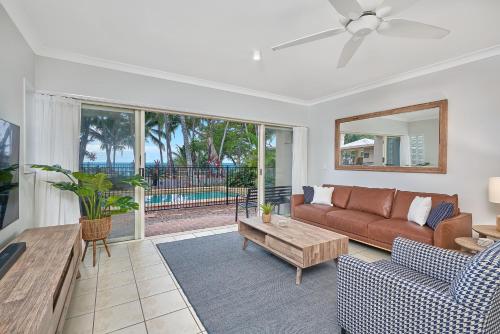 a living room with a couch and a table at Coral Views at Clifton Beach in Clifton Beach