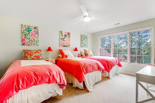 two red beds in a white room with windows at Bayside Bethany Lakes --- Old Mill Way #6 in Ocean View