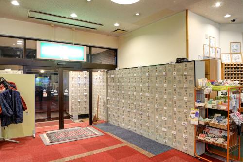 a store aisle with a wall of merchandise at ホテルスターらんど in Tsuru 