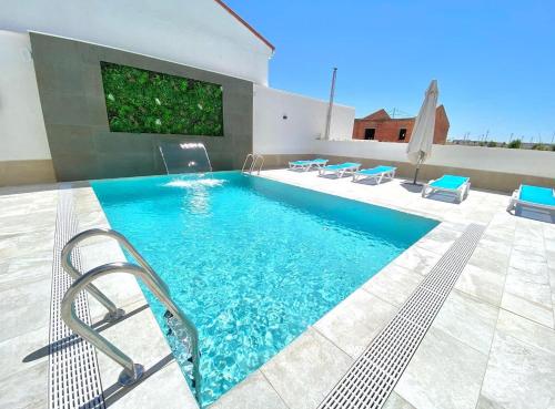 a swimming pool with blue water in a house at Hotel Don Pepo in Lobón