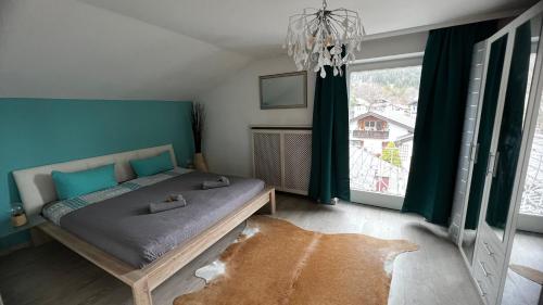 a bedroom with a bed and a large window at Yeti Lux - Panoramic Loft in Garmisch-Partenkirchen