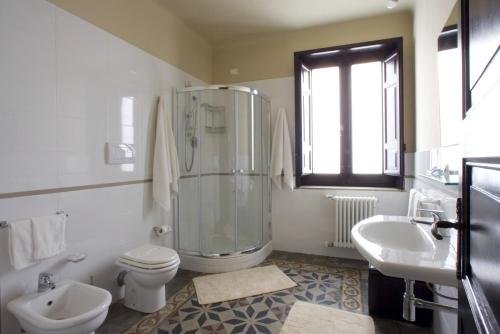 a bathroom with a shower and a toilet and a sink at Alla Marina Bed And Breakfast in Trapani