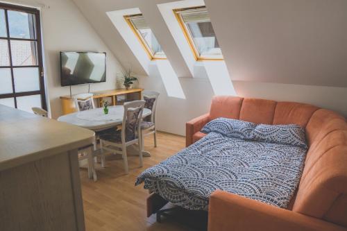 a living room with a couch and a table at Apartment Amak with free onsite parking in Bovec