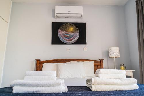 a bedroom with a bed with three towels on it at Anemomylos guesthouse in Paralimni