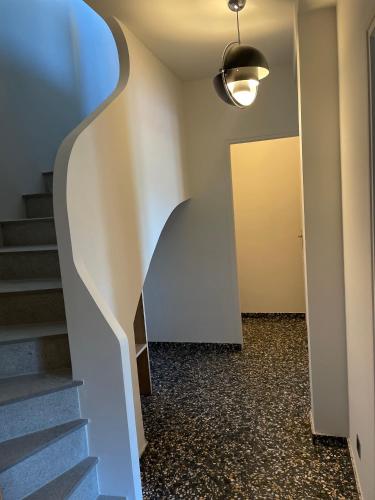 a hallway with stairs and a wall with a door at Villa familiale avec vue imprenable in Saint-Raphaël