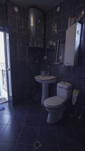 a bathroom with a toilet and a sink at NOD VILA in Chakvi