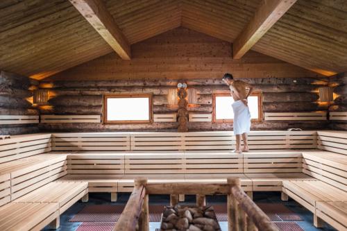 a man standing in the middle of a room in a cabin at Alpenlodge Bad Mitterndorf in Bad Mitterndorf