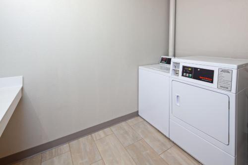 a white washer and dryer in a room at Holiday Inn Palmdale-Lancaster by IHG in Palmdale
