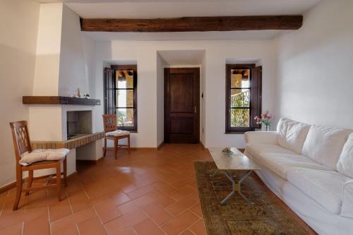 a living room with a white couch and a table at Ginepro Poderone in Grosseto
