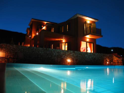 a house with a swimming pool at night at Villa Brio in Skala Kefalonias