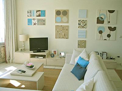a living room with a white couch and a tv at Villa Brio in Skala Kefalonias