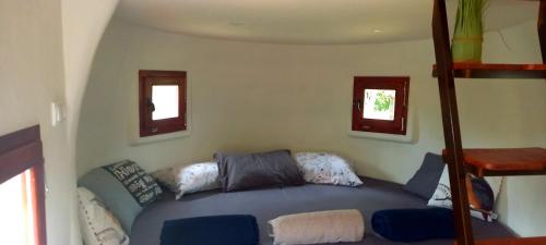 a living room with a couch and two windows at Krka Magic Pumpkin in Rupe