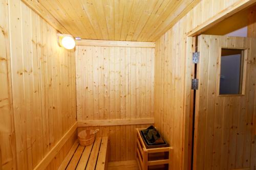 a wooden sauna with a light on the ceiling at Siri Hotel Lumphun in Ban Pa Daet