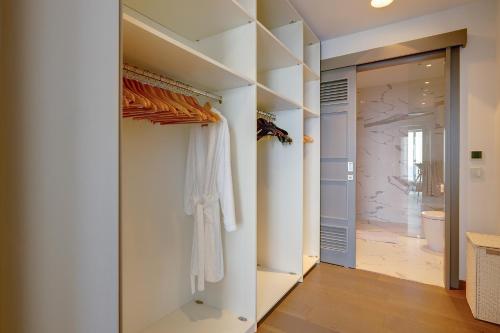 a walk in closet with white walls and a door at Super Luxury Apartment in Tigne Point, Amazing Sea Views in Sliema