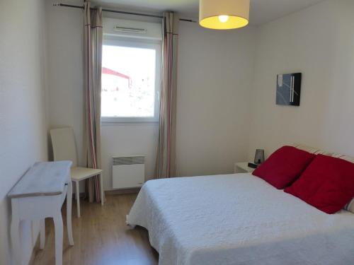 une chambre avec un lit blanc et une fenêtre dans l'établissement Appartement Pour 4 Personnes- Residence L accalmie, à Capbreton