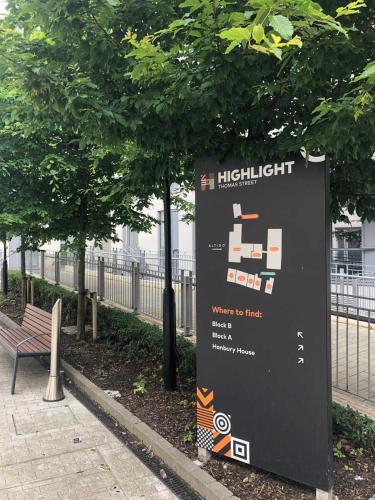 a sign in a park next to a bench at JOIVY Affordable Dublin Thomas Street - Adults only in Dublin