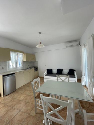a kitchen and dining room with a table and chairs at Villa Maniati Studios in ayios Petros