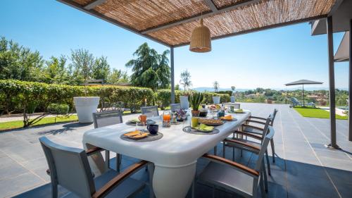 a white table and chairs on a patio at Villa Atmosfere 8, Emma Villas in Colle Alto