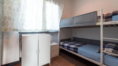 a bedroom with two bunk beds and a window at Villa Atmosfere 8, Emma Villas in Colle Alto