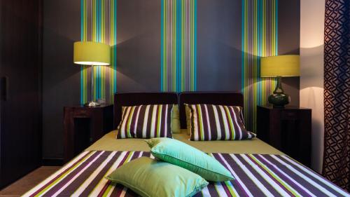 a bedroom with two beds with pillows on them at Villa Atmosfere 8, Emma Villas in Colle Alto