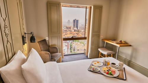 a hotel room with a table with a tray of food at The Cettia Istanbul in Istanbul