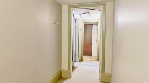 an empty hallway with green walls and a doorway at The Cettia Istanbul in Istanbul