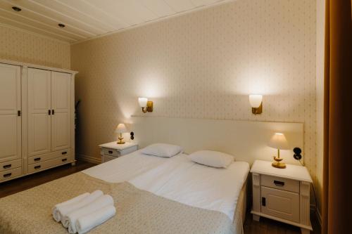 a bedroom with a large bed with two night stands at Pargimaja Apartments in Kuressaare