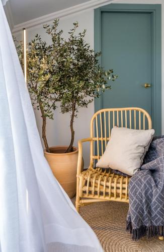 a room with a chair and a potted tree at Hotel Montjoi by Brava Hoteles in Sant Feliu de Guixols