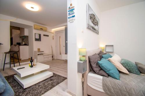a bedroom with a bed and a living room at Oasis apartment in Pula