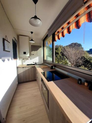 une cuisine avec une grande fenêtre et un comptoir dans l'établissement Appartement à Fréjus, à Fréjus