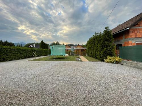 a blue chair sitting in the driveway of a house at Apartmán Klaudia in Ružomberok