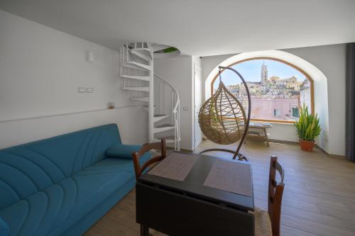 a living room with a blue couch and a table at The View Matera in Matera