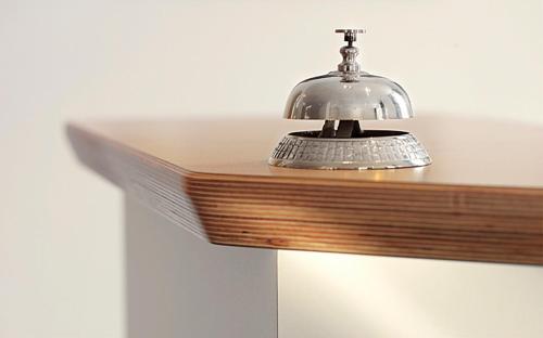 a silver light on top of a wooden table at Hotel Domicil Lebensart in Neuenhaus