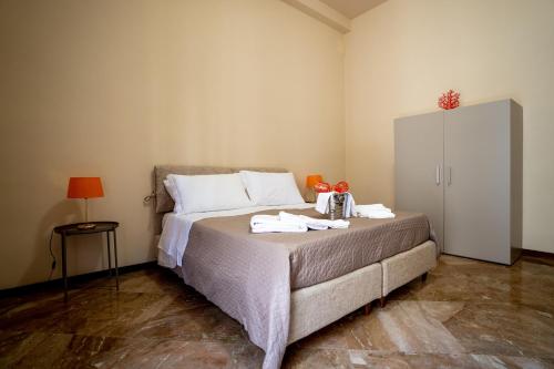 a bedroom with a bed with towels on it at La Loggia di Trapani in Trapani
