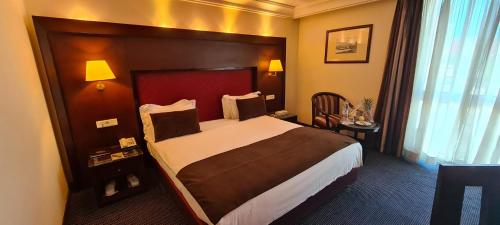 a bedroom with a large bed in a hotel room at Hotel Borj Rabat - A member of Barceló Hotel Group in Rabat