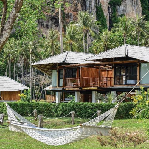 a hammock in front of a house at Tinidee Hideaway Tonsai Beach Krabi - SHA Extra Plus in Tonsai Beach