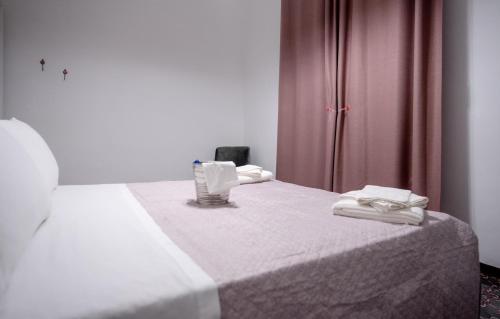 a bedroom with a bed with towels on it at La Loggia di Trapani in Trapani