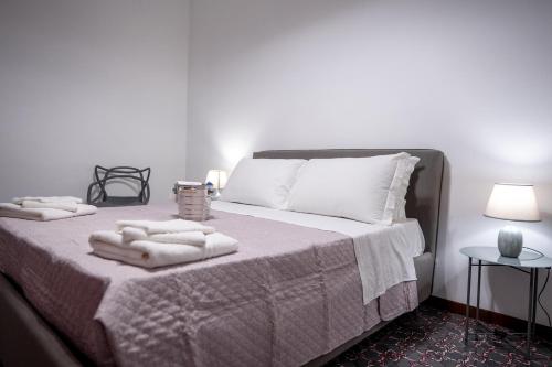 a bedroom with a bed with towels on it at La Loggia di Trapani in Trapani