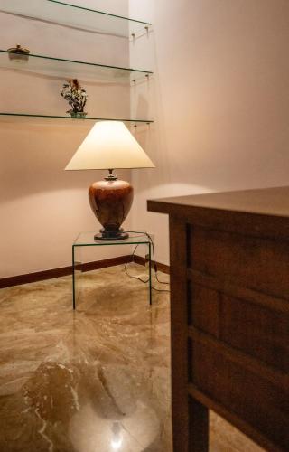 a lamp sitting on a glass table in a room at La Loggia di Trapani in Trapani