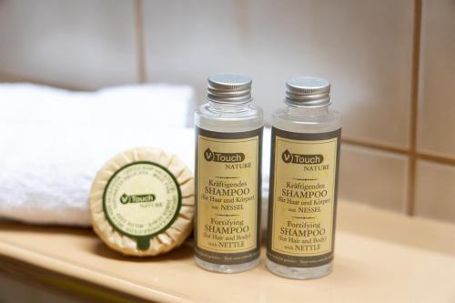 two bottles of mustard on a counter in a bathroom at Landhaus Goldener Apfel in Bolsterlang