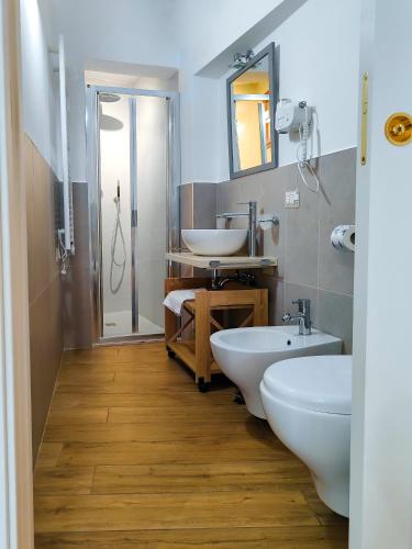 a bathroom with two sinks and two toilets at The View Matera in Matera