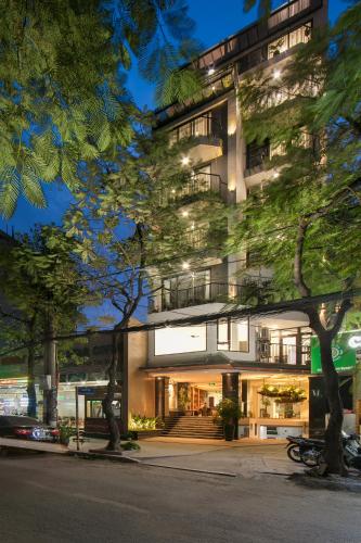 a building with trees in front of it at The Bloom Hanoi - Bespoke Living in Hanoi