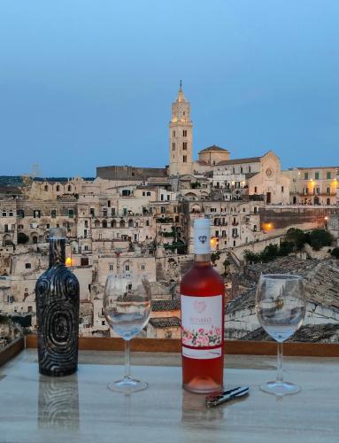 a bottle of wine and two wine glasses on a table at The View Matera in Matera
