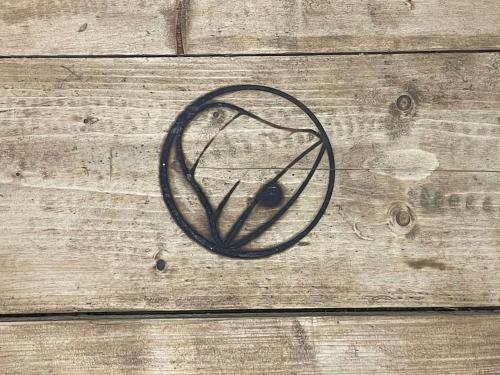 a wooden door with a peace sign painted on it at The Mash Tun - monstrous swank in a sleepy village in Whaplode