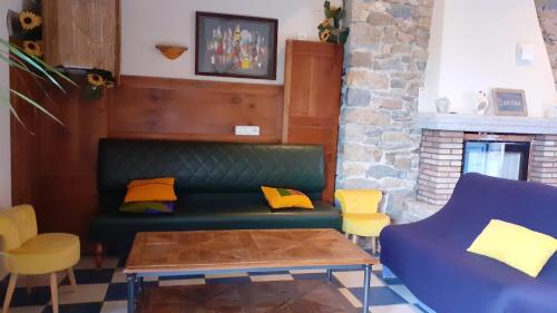 a living room with a green couch and yellow pillows at Maison de 3 chambres avec jardin clos et wifi a Mouzillon in Mouzillon