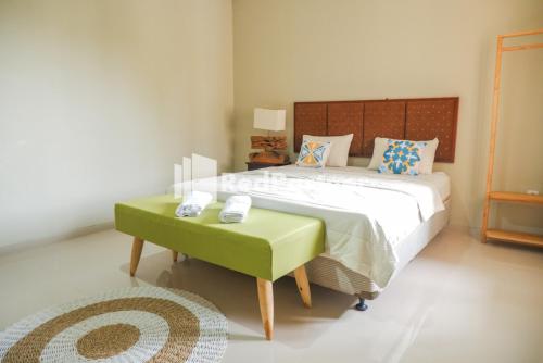 Ein Bett oder Betten in einem Zimmer der Unterkunft Rumah CIA Taman Siswa near Malioboro Yogyakarta Mitra RedDoorz