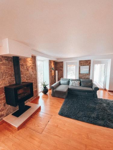 a living room with a couch and a fireplace at Casa da Aldeia in Constância