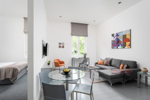 a living room with a couch and a table at Templeton Place by Supercity Aparthotels in London