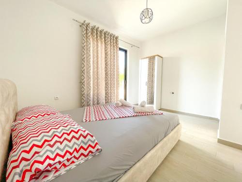 a bedroom with a bed and a window at Rion Apartments in Ulcinj